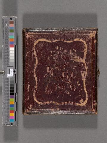 John B. Colton standing with hands in pockets