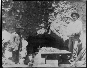 Two construction workers building the arch in the intake tunnel at Mill Creek #3 Hydro Plant