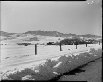 Barn and farm in a snow covered valley