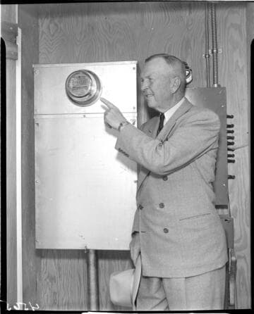 Man pointing to installed "One Millionth Meter" at the job site