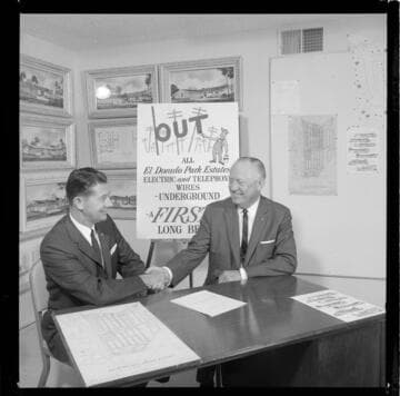 Developers on location with plans for recently built "Eldorado Park Estates" featuring underground service of electric and phone service wires