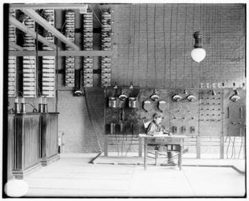 An operator sitting at the desk in front of the switchboard at the Pomona Substation