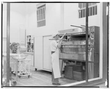 Market Spot All Electric Bakery - Man using oven