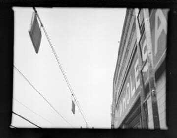 Power lines with warning signs close to building and fire escapes