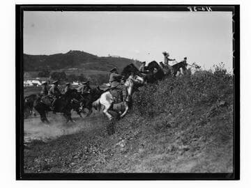 Boys charging up a hill on horseback, Urban Military Academy, Brentwood, Los Angeles