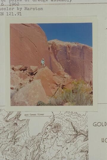 Harry Aleson standing on rubble below drainage off cliff at back of point of dredge assembly