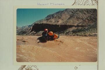 In the river after embarking from 222 Mile Canyon with lava remnant in background