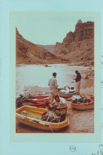 Loading the Yaks at camp at Mile 202.25, right bank.  Rapid No. 23 is below--The Buzzter.  Jorgen Visbak in foreground.  Buzz Belknap and Dock Marston