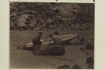 Working the "WEN" off the rocks in Marble Canyon, Mile 24-25.  Nevills sits at left,  Southworth wears the white shirt