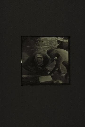 Repairing the CACTUS at the foot of Tuna Creek Rapid.  Belknap and Taylor fashioning a patch