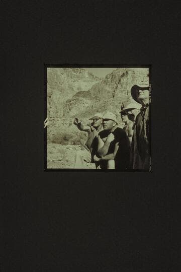 Rod Sanderson shows the path he has selected through Lava Falls.  Belknap seems impressed.  Masland, Marston, and Taylor look as though they understood