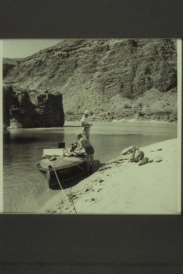 The Chris-Craft in the lagoon at the mouth of Tapeats Creek.  Guy Forcier stands on the after deck while Dock Marston stows gear
