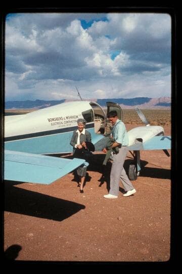 MGM is helped from plane by John Hamilton; Cliff Dwellers Lodge