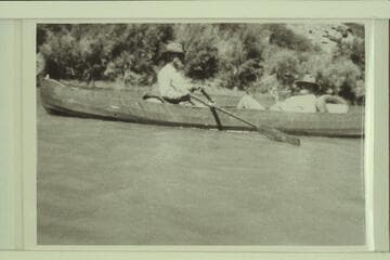 Dave Rust rowing one of his folding canvas boats in Glen Canyon in July, 1930.  George C. Fraser sits in the stern.  The journey was from Hite to Lees Ferry on the river