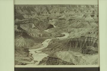 View down the Grand Canyon with the river first appearing at the foot of the Tanner Trail at Mile 68.  In the big loop in the center of the picture marks the disappearance of the river into Unkar Rapid at Mile 72.  Red Butte is on the skyline