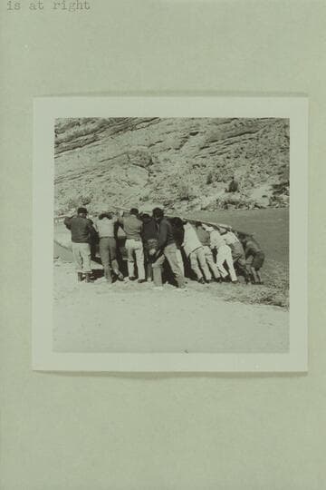 Crew rolling the "Emma Dean" to attach a cable.  Filming of "The Colorado River Story" by Disney above Moab near Castle Creek.  Tom Coleman, left, Jim Drury is second, Russ Haverick with long coat, center, Frank Turner in white pants, Roy Bolton, right