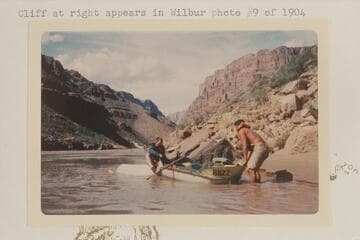Buzz helping John Evans after capsize below Fall Canyon.  Cliff at right appears in Wilbur photo #9 of 1904