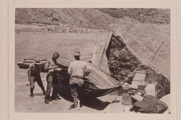 The "Marble" beached for repairs below Badger Creek Rapid.  L to R:  Kolb, Lint and Moore