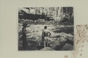 Don Harris points out course in Dark Canyon Rapid to Jack Brennan