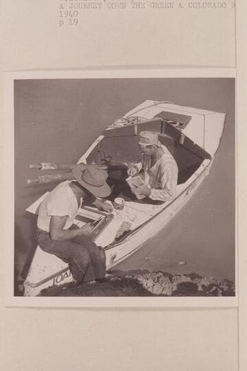 Repairing the sadiron "Joan" after damage at Rapid 23 in Cataract Canyon.  Nevills wears his cap backwards and his pajama top