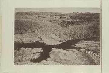 "On the extreme right is the west end of Grand Canyon where the river breaks through the Hualapai Cliffs and joins Lake Mead."  Grapevine Wash is lower right.  Grand Wash is upper left.  The lake is partially filled