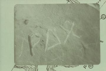 Inscription at Rippling Brook.  P carved very deep; appears the AX was added later; not as deep as the P