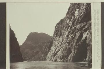 Black Canyon looking downstream at abutments of lower Black Canyon Dam site from Nevada side.  Site is lower end of first canyon.  Geologist F. L. Ransome in boat