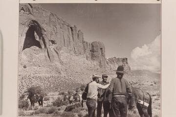 Arch in the Sky.  South end of Cummings Mesa.  Tom Daly, Bahe, White-hat ready the packs