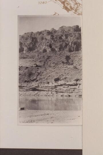 Oil sand directly across river from seeps Waterpocked Fold.  Note Wingate in cliffs above