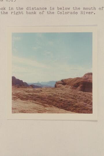 Southwest from summit between side canyon of Glen Canyon at Mile 83-84 and the route of the Mormon trek thru Hole in the Rock and Wilson Creek which drains into the San Juan River at Mile 14