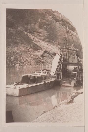 The drill barge at Glen Canyon Damsite.  The Higgins boat was used to carry freight up from Lees Ferry