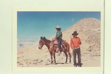 Buck Whitehat and Tobe Owl at upper end of the black brush mesa north of Lehi Canyon.  Fifty Mile Mountain in the distance.  Tobe Owl is the younger brother of Nasja Begay