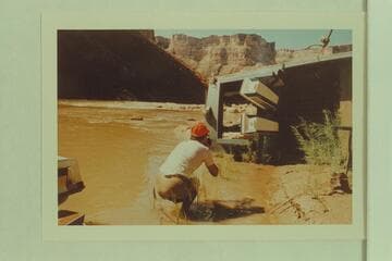 The "Kitty" rolled for repairs above Soap Creek Rapid.  She sprang some inner plies when landing.  Frank LaRue is the photographer
