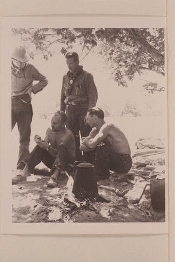 Charles Larabee standing; Buzz Holmstrom and Norm Nevills seated.  Pats Hole