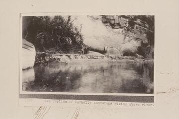 Red portion of Coconino-Kaibab sandstone rising above river