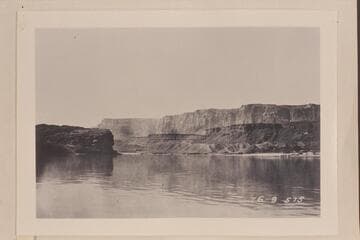 Lower end of Glen Canyon showing Vermillion Cliffs in background.  At Lees Ferry.  The cliffs in the background are the Vermillion Cliffs of the Paria Plateau