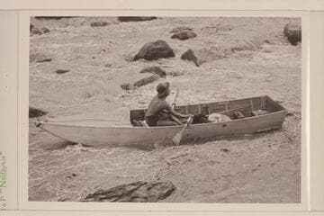 Lorin Bell in Government Rapid, San Juan River.  15-ft. folding boat of the Monument Valley-Rainbow Bridge Expedition borrowed by Nevills.  Flow of the river approximates 400 cfs