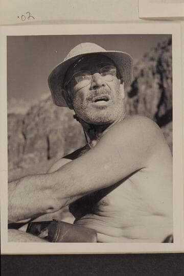 Otis "Dock" Marston answers some questions while piloting the motorboat in lower Grand Canyon