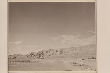 Raplee Anticline at Mexican Hat on the San Juan River.  Nevills home at right.  One of the Nevills boats is on the trailer back of the car