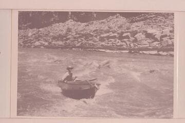 Harry Aleson in Narrow Canyon or lower end of Cataract Canyon.  The boat is the outboard powered "Up Lake."