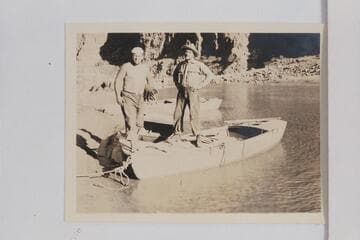Doc Frazier and Bill Fahrni standing on Frazier's skiff at the mouth of Pipe Creek