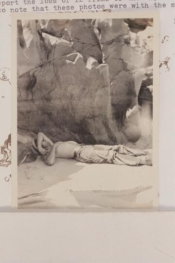 Frank Swain asleep under an overhang at head of Serpentine Rapid.  Noon stop.  Eddy's photo notes report the loss of 12 films of the 4x5 size but he may have failed to note that these photos were with the smaller camera