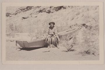 Robert N. Allen sitting on boat with fish string