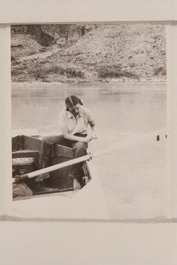 Anne Desloge cleaning fish.  The boat is moored at the beach on right bank below Tapeats Creek