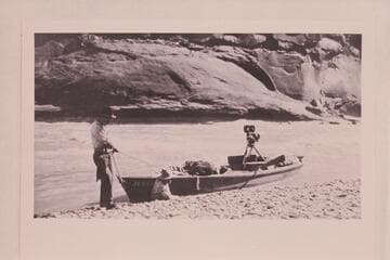 Skiff of Lasky party in small rapid just below Hite.  Jesse Lasky, Jr., and Kenneth Wortley