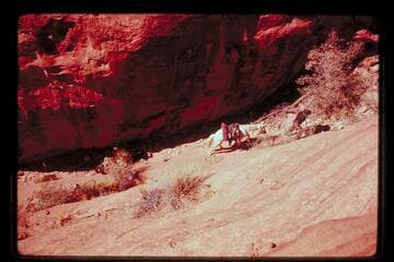 Tobe Owel leads horse up trail north of Cha Butte
