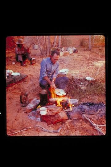 Tom Daly cooks, Buck Whitehat at back, Nasja Creek