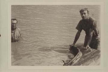 Frank Barnes at left and Duncan Harold McDermid.  Lees Ferry with the sunken launch "Canopy."  Enlarged from negative in Waller collection