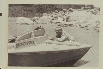 Marston fastening the hatch of the "Bootoo", Mile 24.5 in Marble Canyon