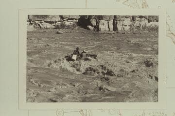The craft swings clear of the hole and turns its bow downriver without aid of motor.  Chas Peterson is in the dark hat at left.  Dock Marston at right and the motor-man is wearing the white preserver.  Coal Creek Rapid